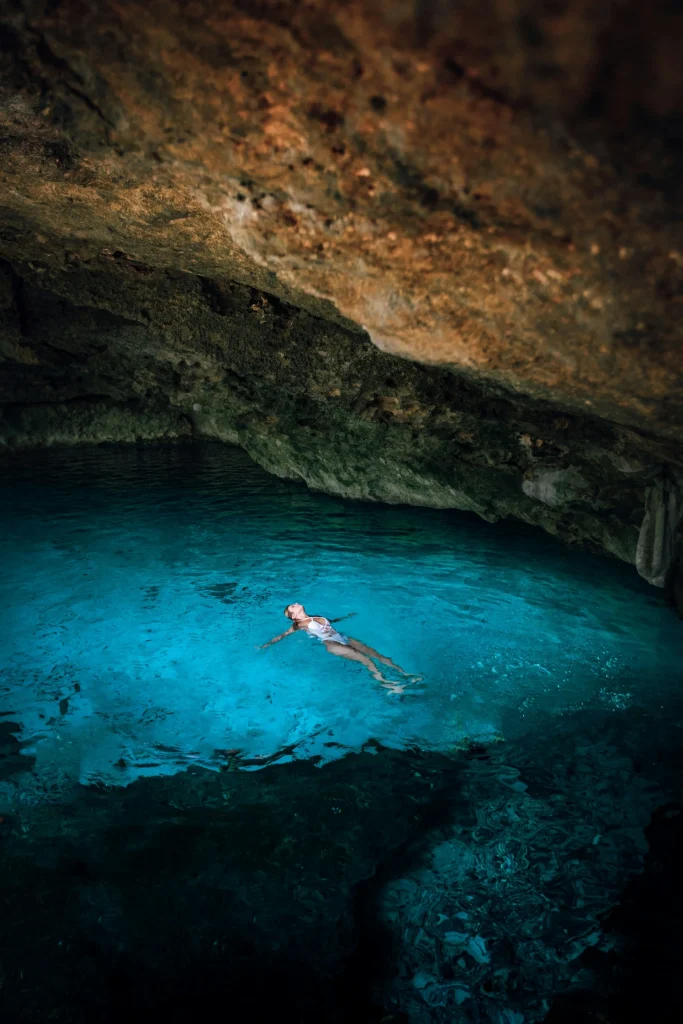 Une femme nageant sous une grotte au Mexique
