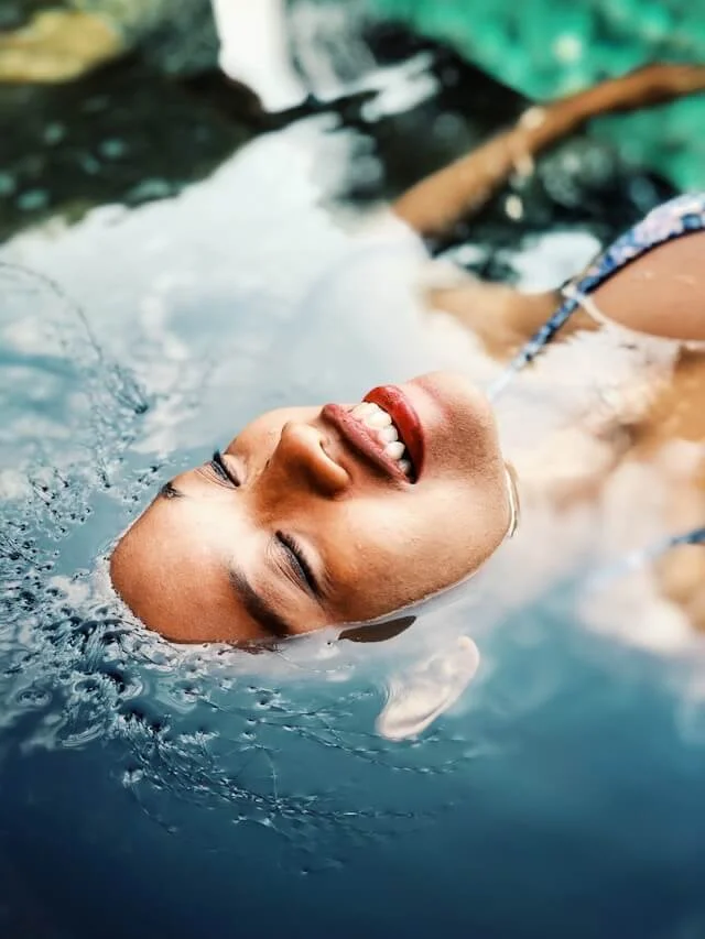 Femme flottant sur un plan d'eau.