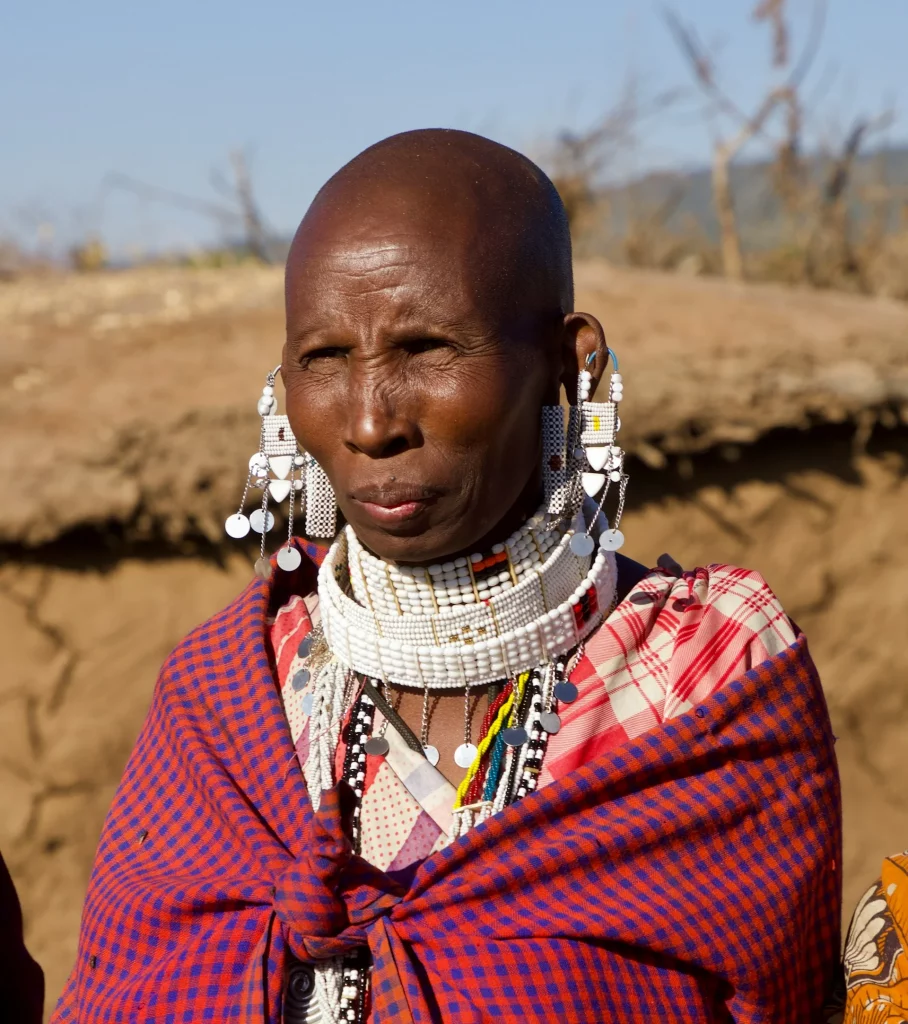 Close-up portrait of a Maasai woman in traditional clothing.